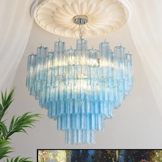 A tiered chandelier with many vertical, translucent, light blue glass rods hanging from a chrome base, illuminated from within.