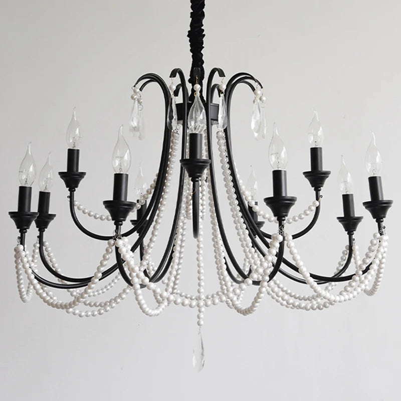 A black, multi-arm chandelier adorned with strings of white pearl-like beads and clear crystal teardrops, featuring candelabra-style light sockets against a plain white background.