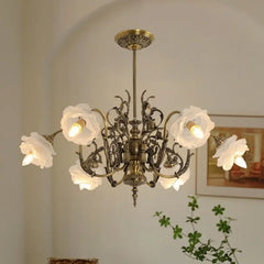 Close-up of a polished copper floral chandelier with illuminated rose-shaped glass shades, showcasing the intricate metalwork.
