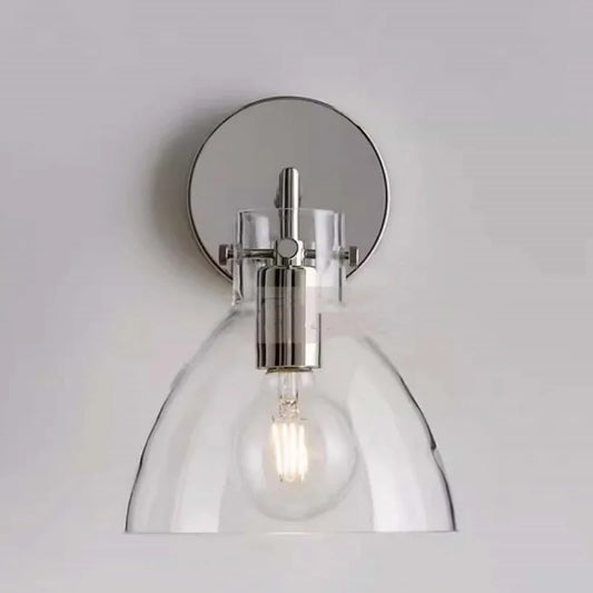 Silver-finished wall sconce with a clear glass dome shade and visible LED bulb.
