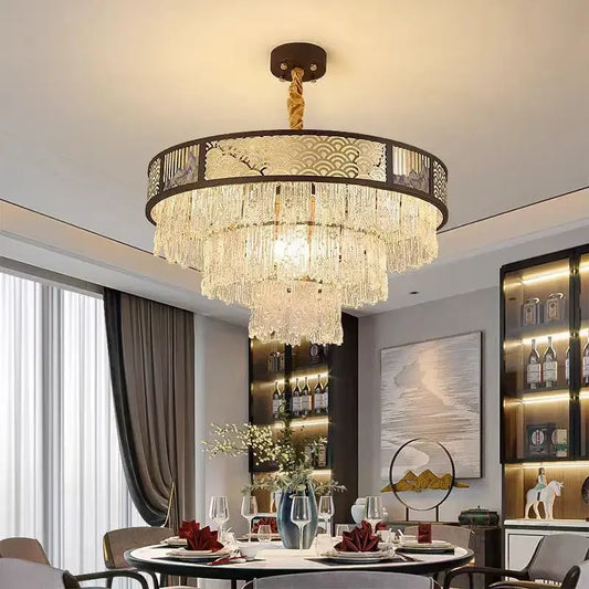 Tiered crystal chandelier with a dark frame and clear crystal droplets, installed in a dining room setting.