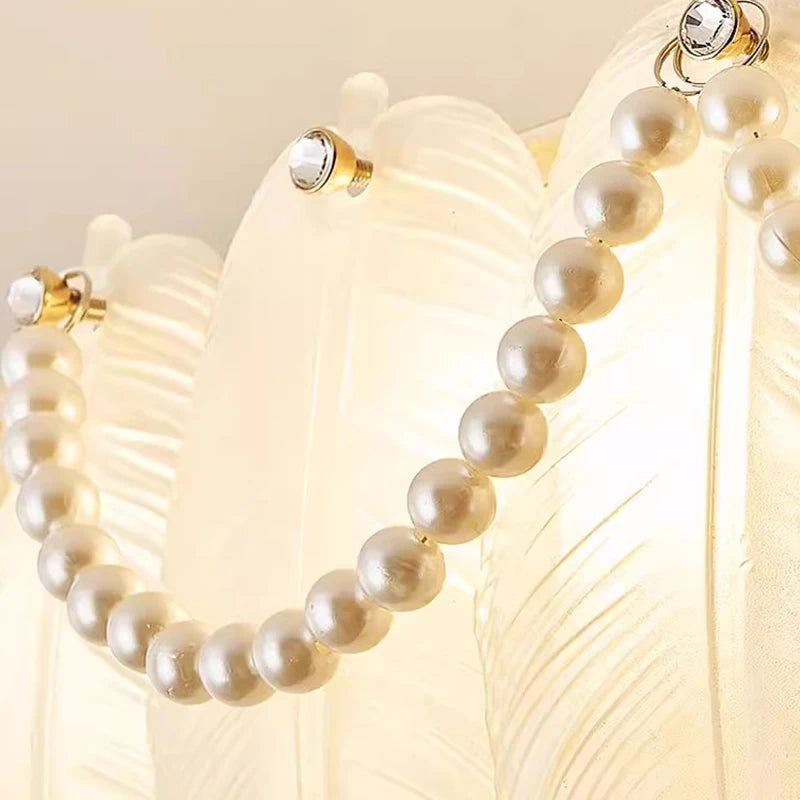 Pearl necklace with gold clasp on a light background
