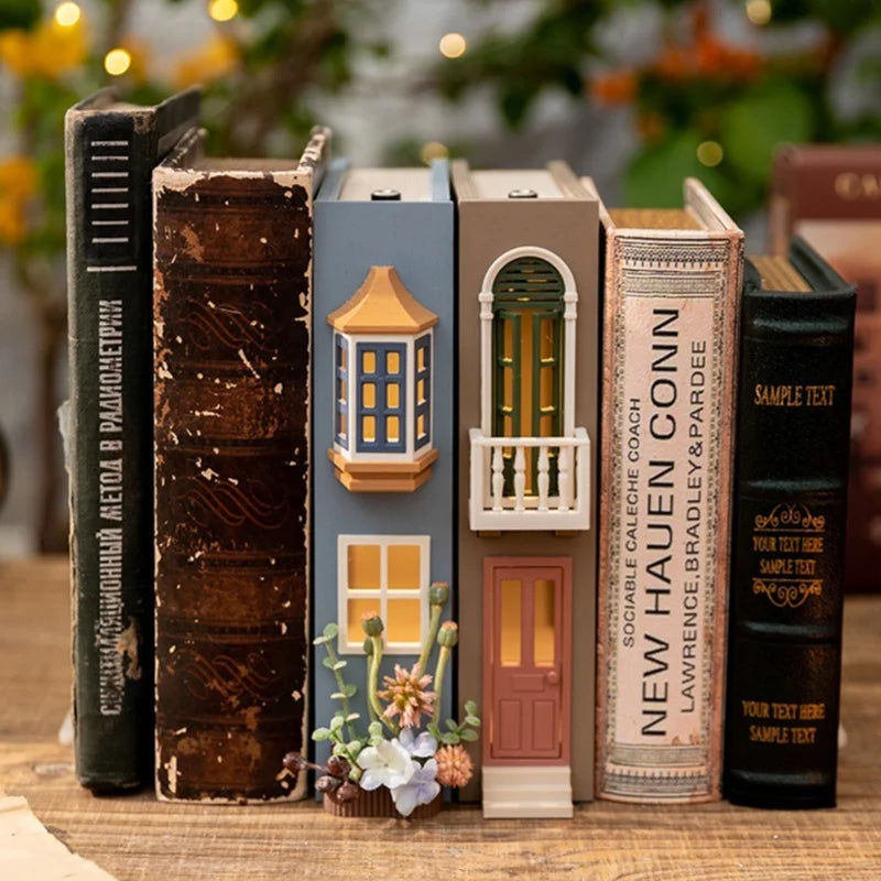 A collection of decorative bookend lamps, including a blue 'Fairytale Forest' design and a brown 'Lucky Traveler' design, arranged on a wooden surface.