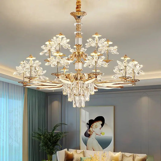 A wide shot of a gold chandelier with crystal flower accents and cascading teardrop crystals illuminating a living room.