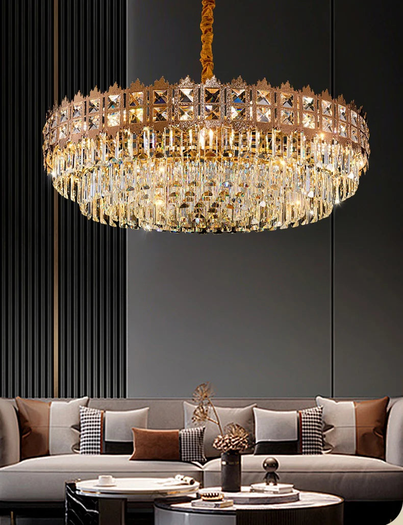 Luxurious chandelier hanging above a modern living room setup with a gray sofa and decorative pillows.