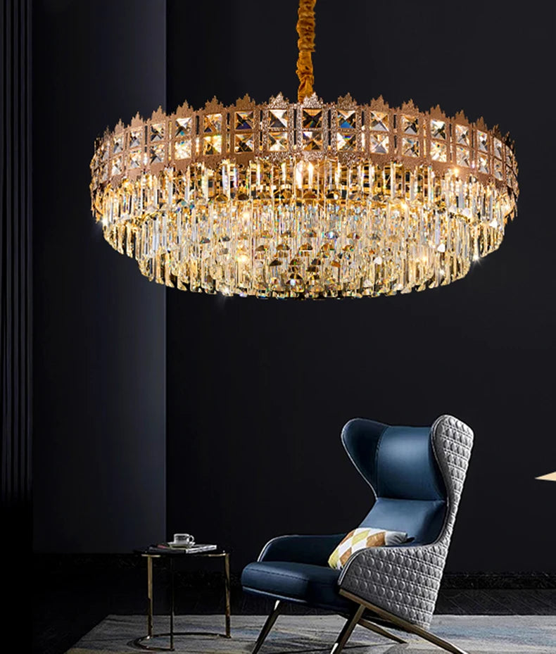 Luxurious chandelier hanging above a modern chair and table in a dimly lit room.