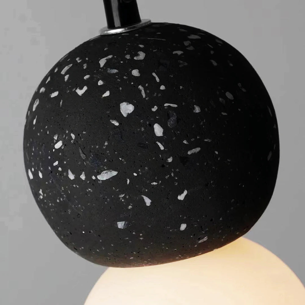 Black textured pendant light against a gray background