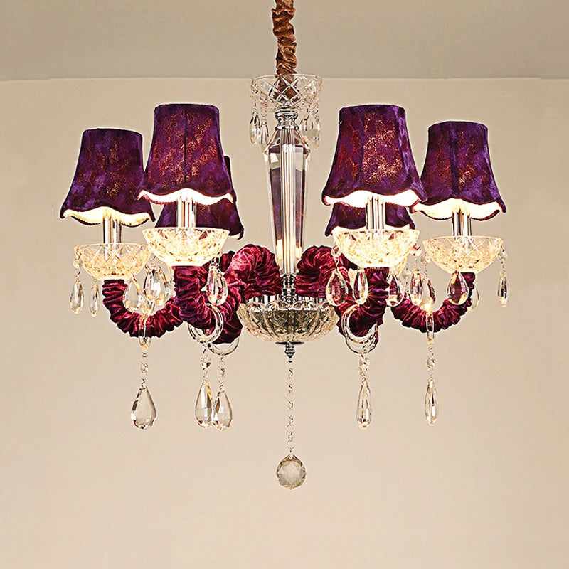 A luxurious 6-head chandelier with purple fabric shades and cascading crystal droplets, featuring a chrome-finished multi-arm structure.