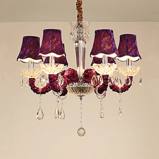 A luxurious 6-head chandelier with purple fabric shades and cascading crystal droplets, featuring a chrome-finished multi-arm structure.
