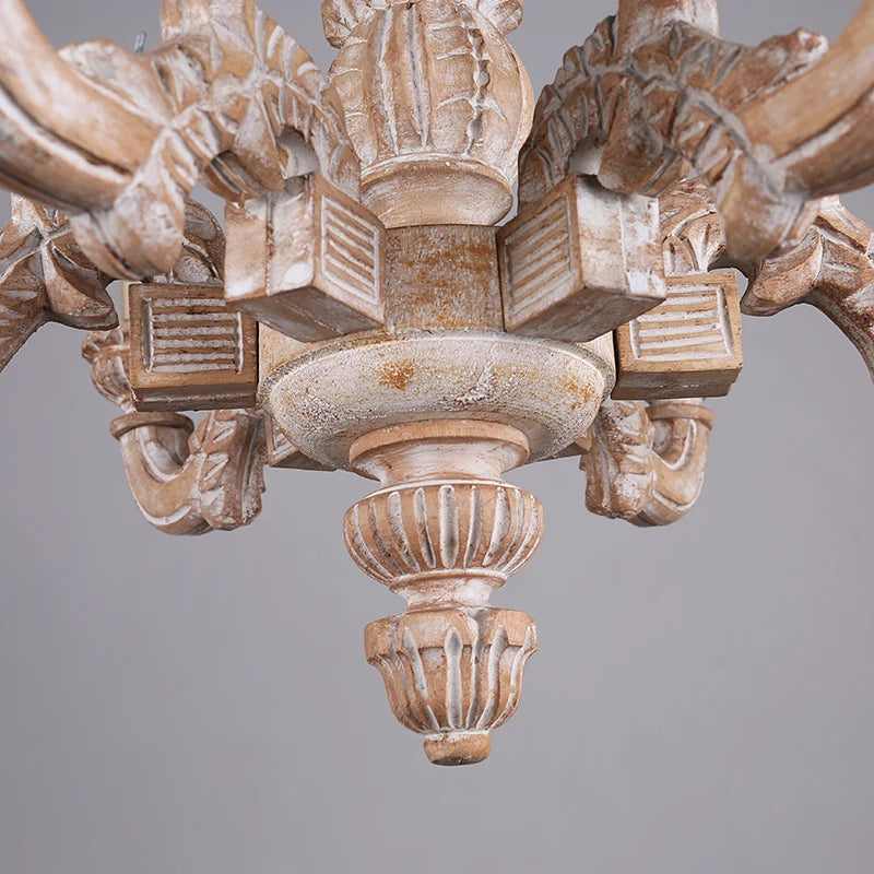 Close-up view of the central column and lower decorative elements of the distressed wood chandelier.