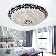 Glass mosaic starburst flush mount ceiling light in a bedroom