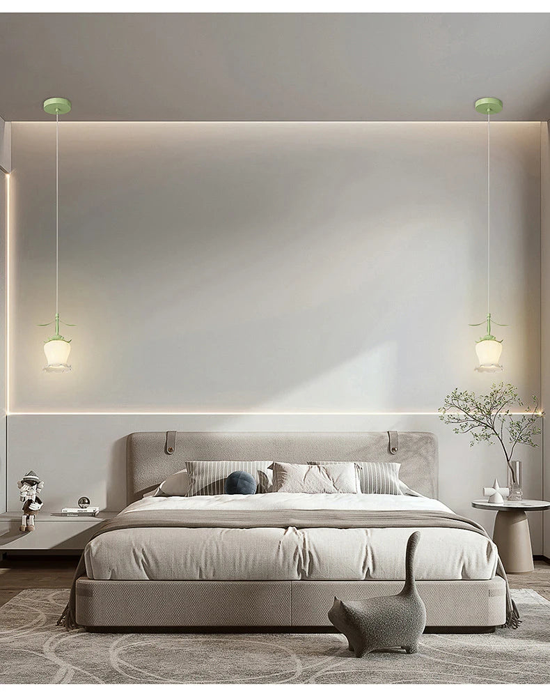 Two flower-shaped pendant lights hanging on either side of a bed in a modern bedroom, with subtle backlighting.