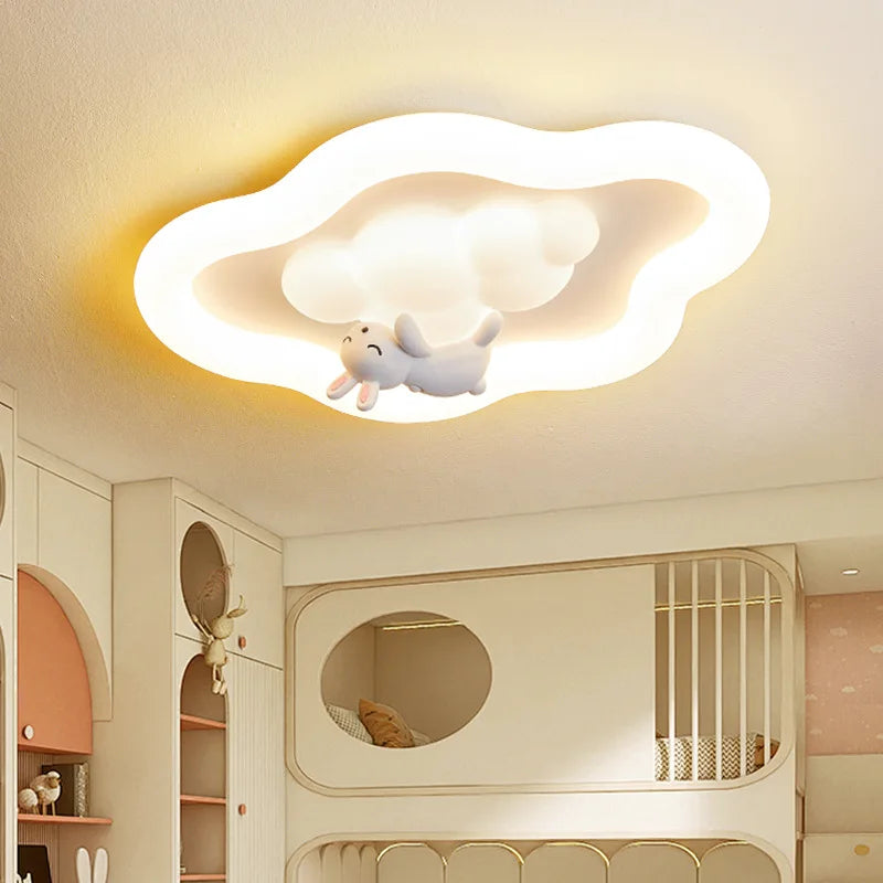 View of a white cloud-shaped flush mount LED ceiling light in a child's bedroom setting.