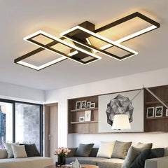 Modern black geometric ceiling light with intersecting rectangular frames, illuminated.