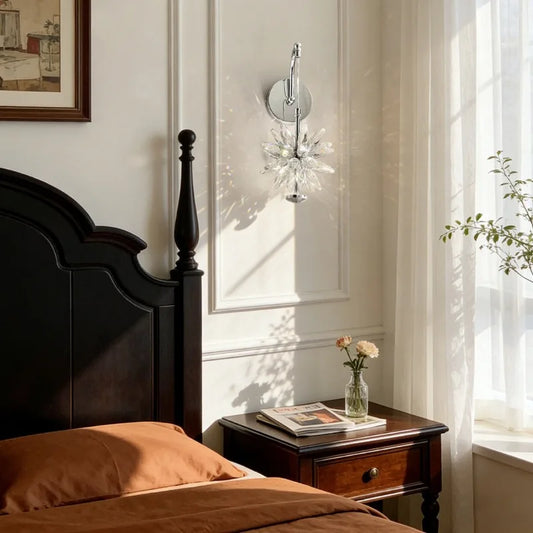 A bedroom scene featuring a dark wood bed and nightstand, with a polished chrome wall sconce emitting prismatic light effects onto the paneled wall.