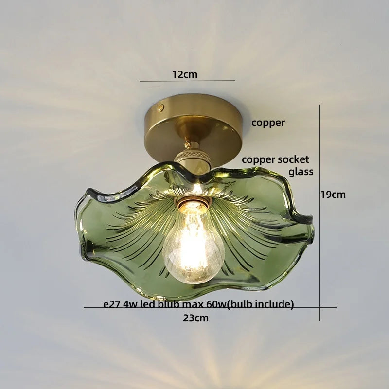 Ceiling light fixture with green glass shade and measurements on a white background