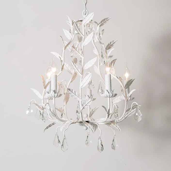 White wrought iron leaf chandelier with clear teardrop crystals hanging from candle-style lights, against a white background.