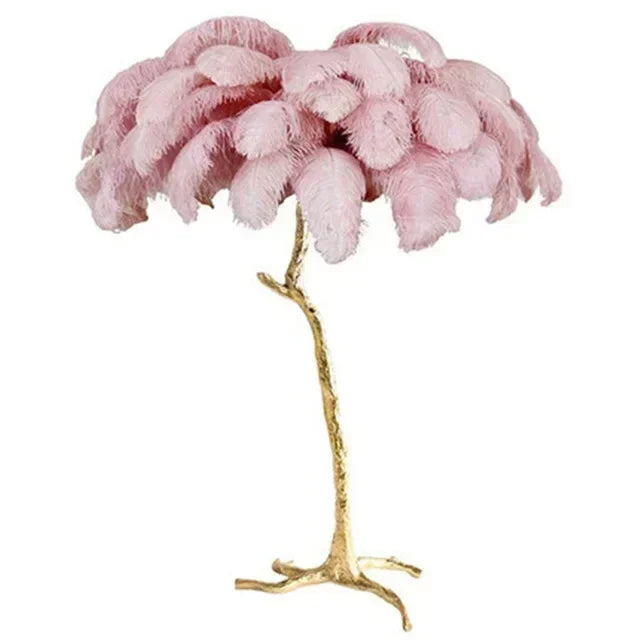Pink feathered lamp with a gold base on a white background