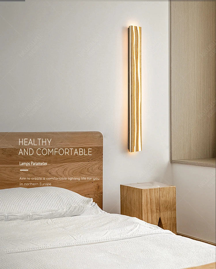 Bedroom with a wall-mounted light fixture, wooden headboard, and nightstand.