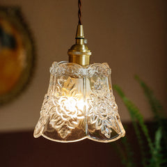 A small, clear glass pendant light with a floral etched design and brass fittings.