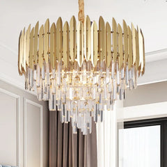 A large gold and crystal tiered cascading chandelier with a golden cord hanging from the ceiling.