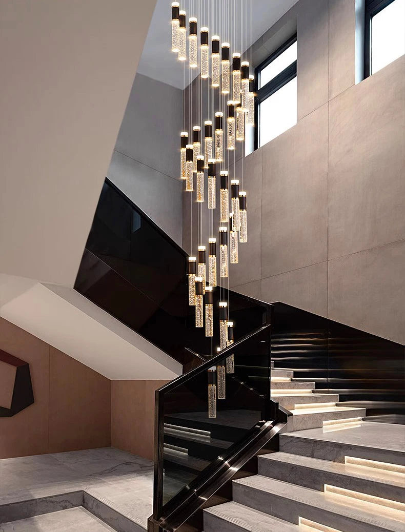 Modern staircase with a decorative chandelier in a stylish interior setting.