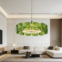 Green glass square geometric chandelier installed in a modern living room setting.