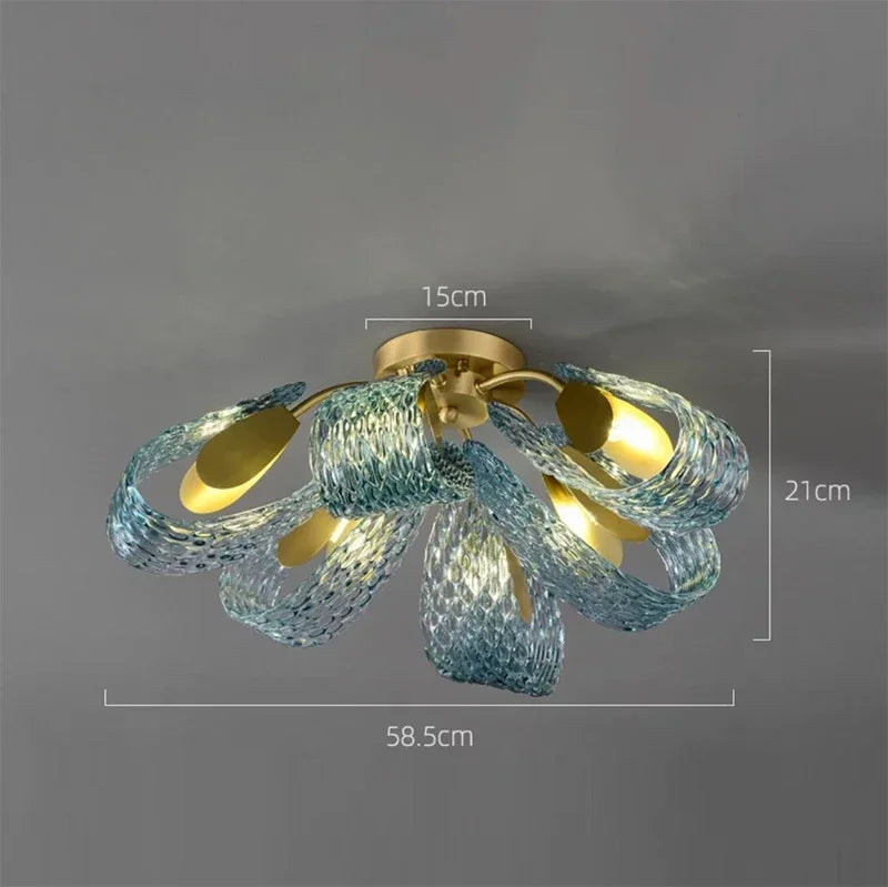 Ceiling light fixture with blue glass shades and gold accents on a gray background