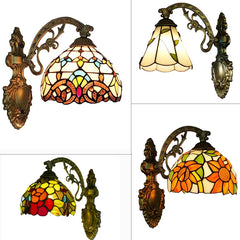 Collage of four Tiffany style wall sconces with stained glass shades in various floral and geometric patterns, mounted on ornate metal arms.