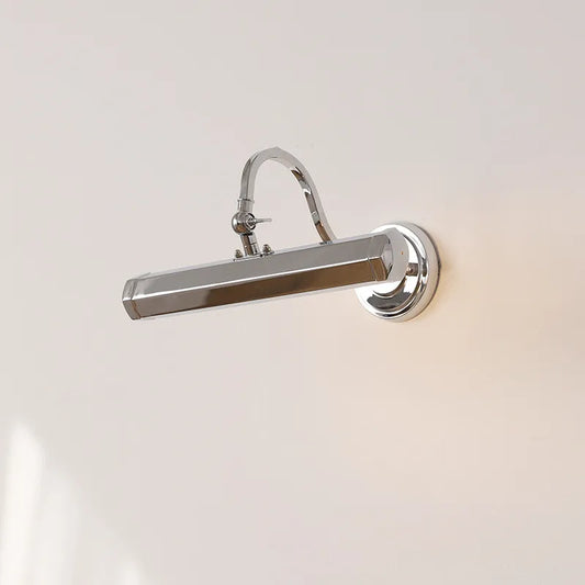 Polished chrome wall sconce with a curved arm and rectangular light head mounted on a white wall.