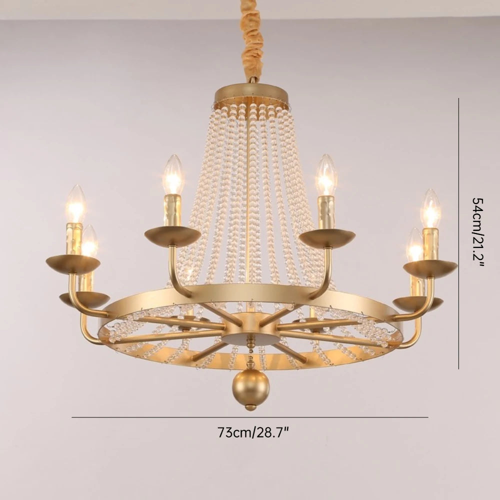 Gold chandelier with crystal accents on a plain background