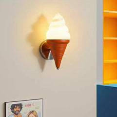 An ice cream cone wall sconce glowing warmly on a beige wall next to yellow shelves.