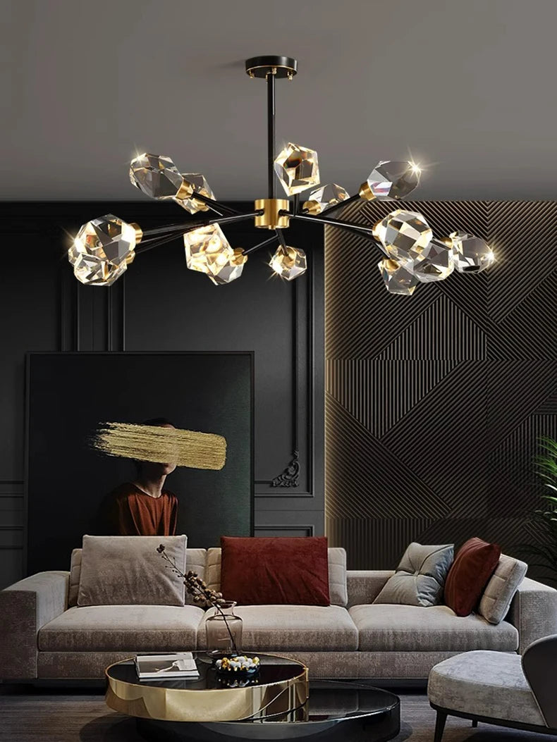 Modern chandelier hanging above a living room with a sofa and decorative pillows.