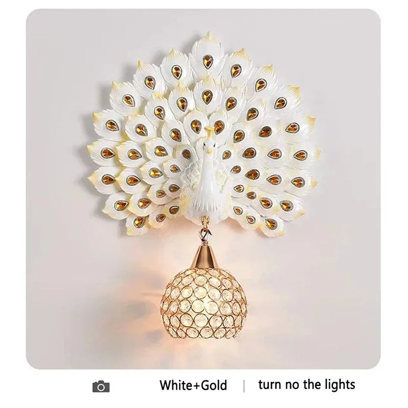 Peacock feather wall light fixture with gold accents on a white background