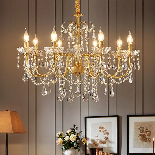 A detailed shot of the gold chandelier showing the intricate metalwork and the arrangement of crystal droplets and pearls.
