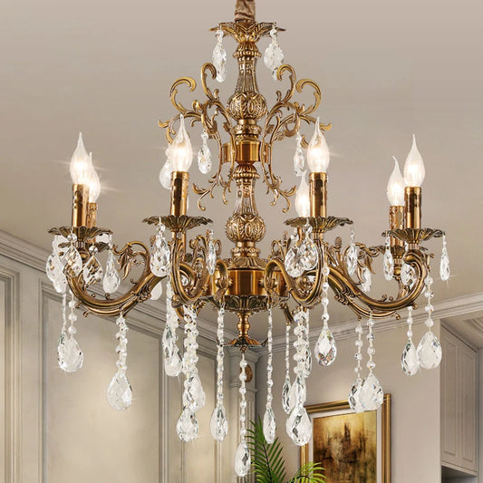 A coppery multi-arm crystal chandelier installed in a room, showcasing its decorative effect.