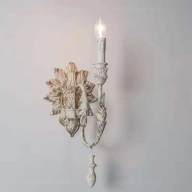 Decorative wall sconce with intricate design on a light gray background