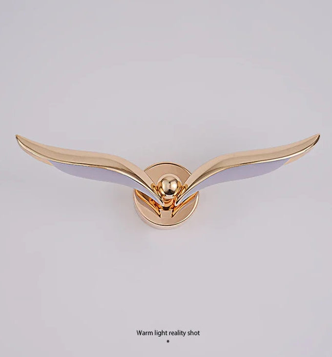 Gold bird-shaped decorative item on a light gray background