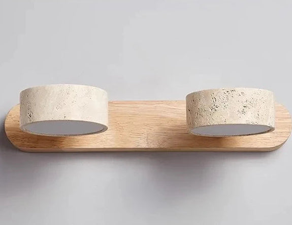 Wall-mounted light fixture with wooden base and stone-like lampshades on a gray background