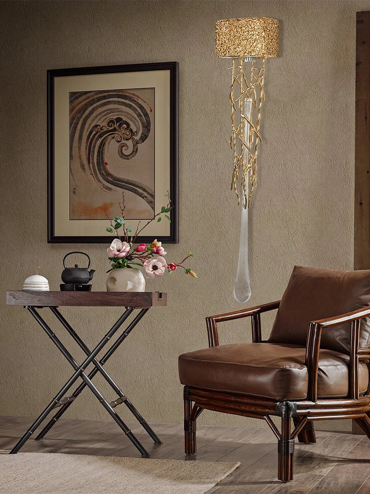 Living room with a brown armchair, wooden side table, and decorative wall lamp.