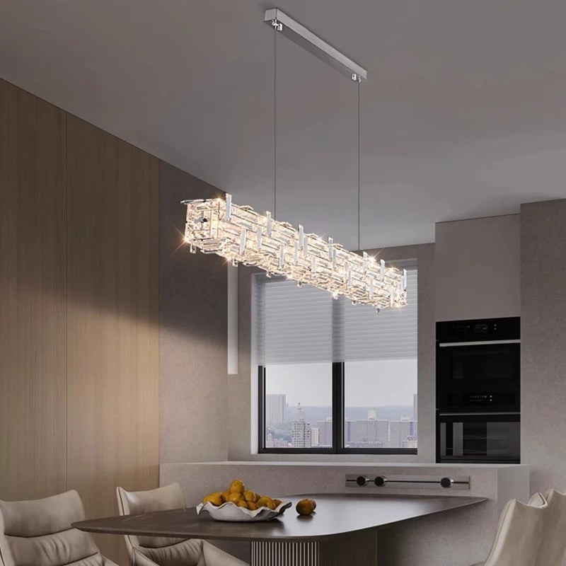 Modern chandelier hanging above a dining table in a stylish kitchen.