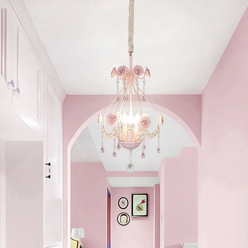 Pink floral crystal pendant light hanging in a hallway with pink walls and white archways.