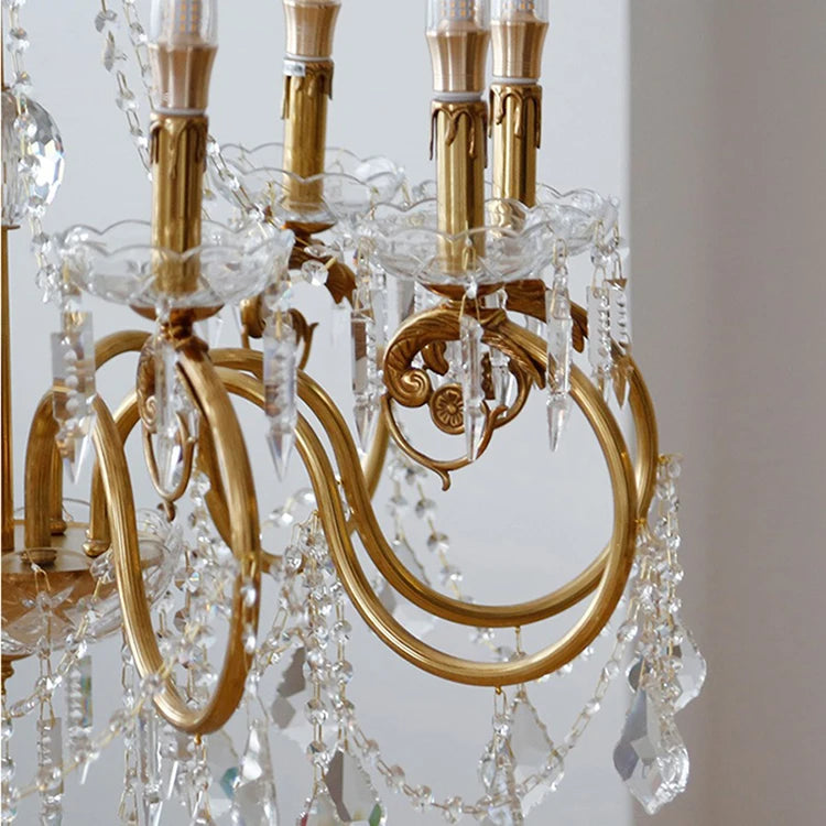 Gold chandelier with crystal elements on a light background