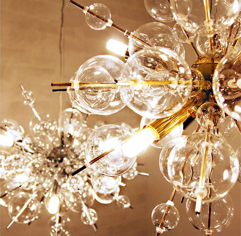 Chandelier with glass bulbs and gold accents against a beige background
