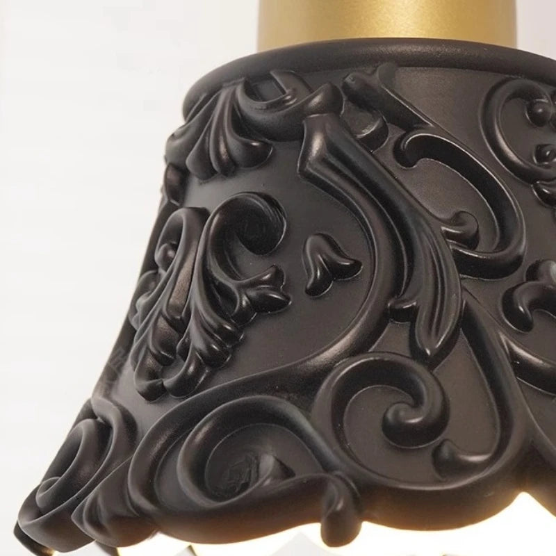 Decorative black lampshade with intricate patterns on a white background