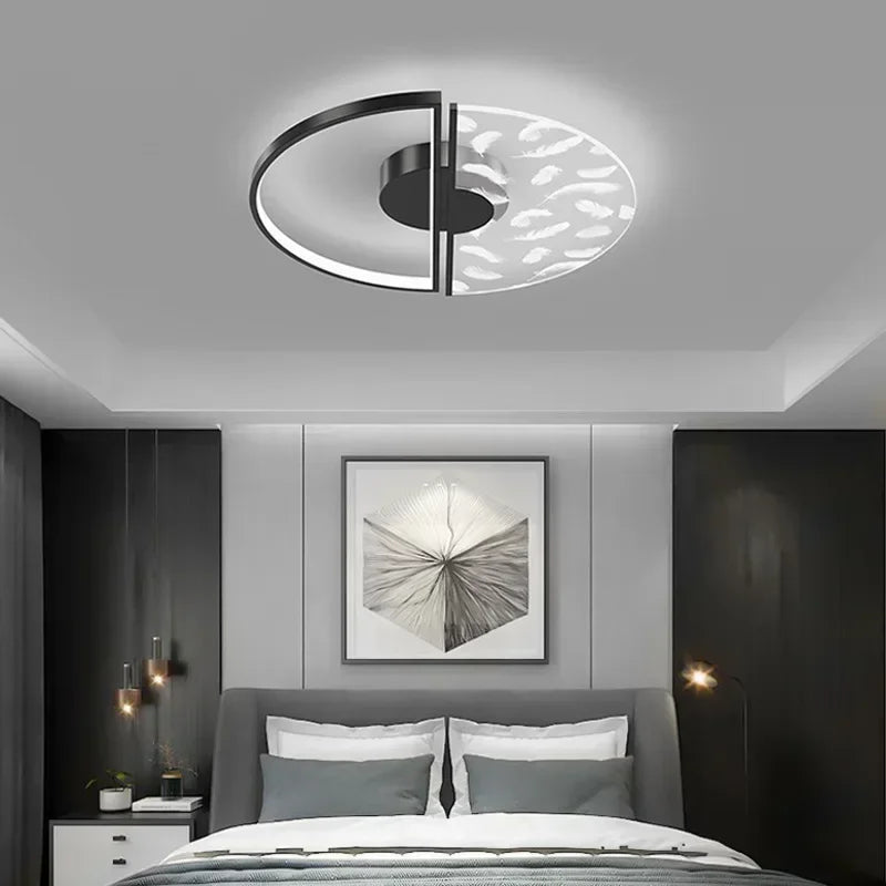 Modern bedroom with a ceiling light fixture, bed, and wall art.