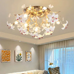 Gold floral chandelier with white petals and crystal accents, flush mounted on a ceiling