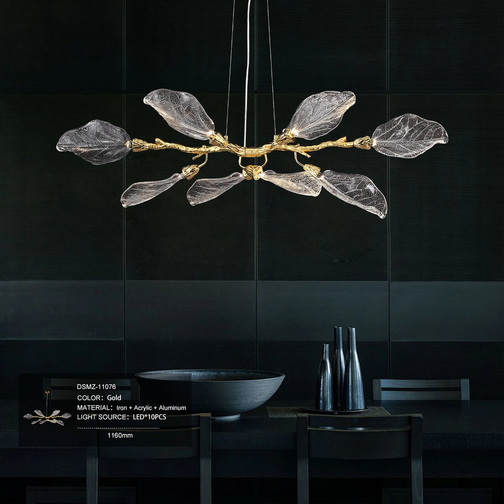 Modern chandelier with leaf-like design on a black tiled wall