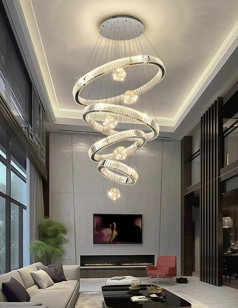 Modern living room with a spiral chandelier, gray walls, and a red chair.