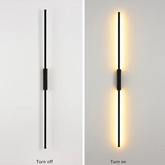 Black linear wall sconce in a turned-off state against a white wall.